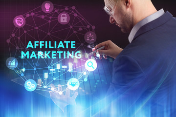 The concept of business, technology, the Internet and the network. A young entrepreneur working on a virtual screen of the future and sees the inscription: Affiliate marketing