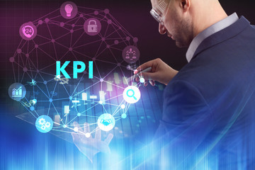 The concept of business, technology, the Internet and the network. A young entrepreneur working on a virtual screen of the future and sees the inscription: KPI