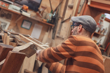 Carpenter sawing wooden detail