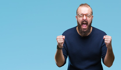 Young caucasian hipster man wearing sunglasses over isolated background cheerful with a smile of face pointing with hand and finger up to the side with happy and natural expression on face