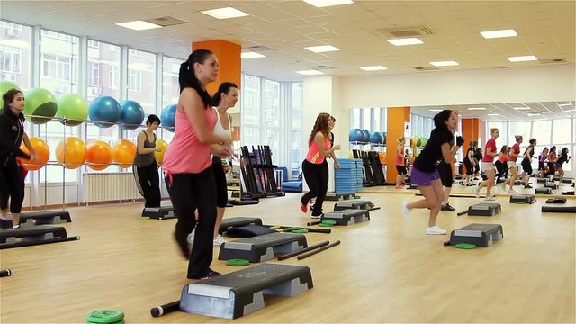 Beautiful female on the step board during exercise.