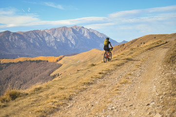 Autumn mountain scene riding with a mountain bike equipped with travel bags