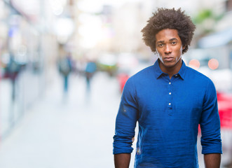 Afro american man over isolated background skeptic and nervous, frowning upset because of problem. Negative person.