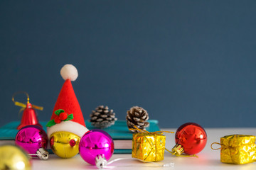 Christmas concept with copy space.Ornament balls, Santa Claus hat and note book with blue background.