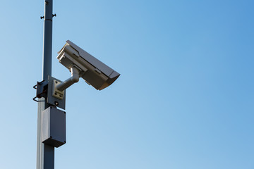 Security camera on blue sky background. Security view post