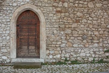Fototapeta na wymiar Old wooden door on Wawel Castle in Krakow