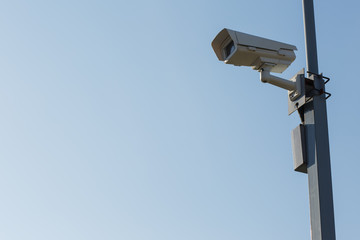 Security camera on blue sky background. Security view post