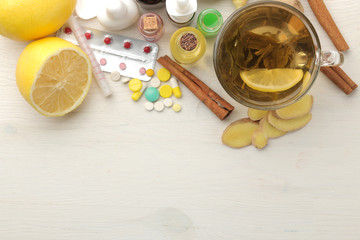 Various cold medicines and cold remedies on a white wooden table. Cold. diseases. cold. view from above