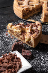 Apple pie whole and slice with chocolate. Traditional sweet pie. Homemade dessert.