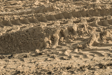 Tires marks on sand background
