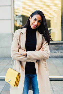 Portrait of a smiling stylish woman in the street.