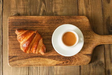 Bread and coffee espresso isolated on wooden table