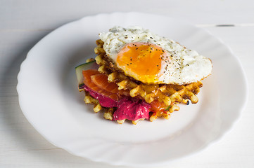 Savory Belgian waffles with egg poached, salmon and salad. eggs