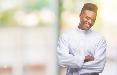 Obraz premium Young arabic african man wearing traditional djellaba over isolated background happy face smiling with crossed arms looking at the camera. Positive person.