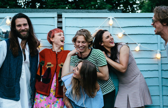 A group of friends messing around and having fun on a patio