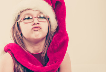 Girl in santa hat making silly face