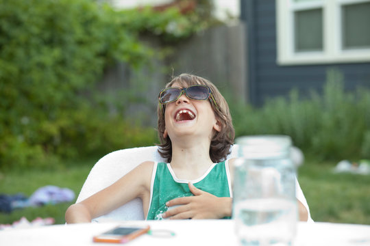 Boy in back yard laughing