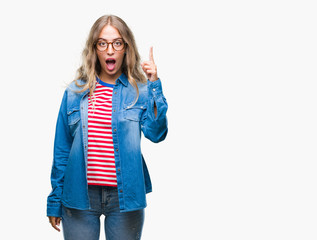 Beautiful young blonde woman wearing glasses over isolated background pointing finger up with successful idea. Exited and happy. Number one.