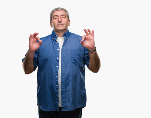 Handsome senior man over isolated background relax and smiling with eyes closed doing meditation gesture with fingers. Yoga concept.