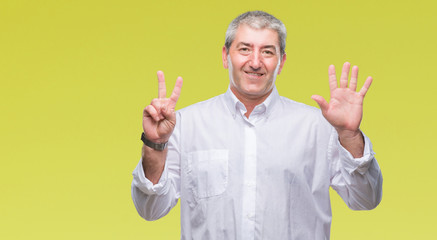 Handsome senior man over isolated background showing and pointing up with fingers number seven while smiling confident and happy.