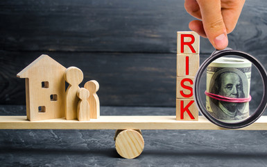 wooden house and cubes with the word risk. The concept of risk, loss of real estate. Property...