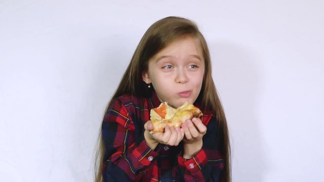 Little child girl eating chewing a piece of pizza