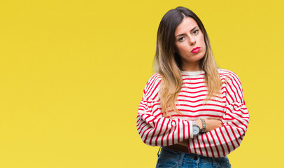 Young beautiful woman casual stripes winter sweater over isolated background with serious expression on face. Simple and natural looking at the camera.