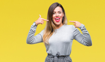 Young beautiful worker business woman over isolated background smiling confident showing and pointing with fingers teeth and mouth. Health concept.