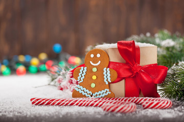Fototapeta na wymiar Christmas gift box, candy canes and gingerbread man