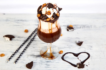 Extreme milkshake with chocolate, cookies and sweets.