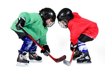 Boy playing ice hockey. Little hockey player isolated on white background.