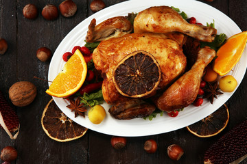 Baked turkey or chicken. The Christmas table is served with a turkey, decorated with fruits, salad and nuts. Fried chicken, table. Christmas dinner