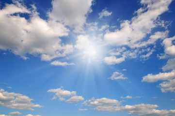 Naklejka na ściany i meble Sun on blue sky with white clouds.