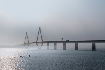 faro bridge in foggy weather, the highway bridge over the Storstroem in denmark connects the islands and is a part of the vogelfluglinie (bird flight line)