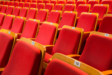 Naklejka premium Red chairs in the auditorium of the theater or concert hall.
