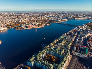 Fototapeta na wymiar Top view aerial drone on buildings Palace embankment, wide Neva river with boats, bridge. Hare island and Peter and Paul fortress.