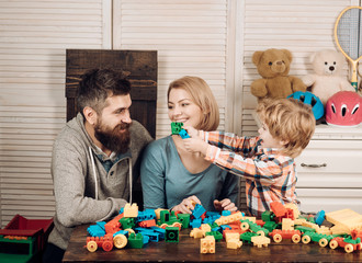 Naklejka premium father and mother with child play constructor. happy family and childrens day. Little boy with dad and mom. little boy play with parents at home. happy childhood. Care and development. Our union