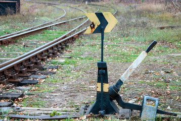 old rusty railway arrow to move the rail in the right direction
