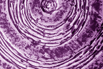 Part of old ceramic plate close-up in purple tone.