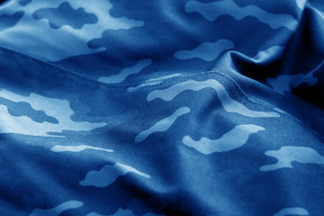 Old camouflage cloth with blur effect in navy blue tone. © pavelalexeev