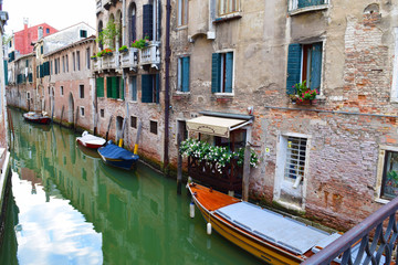 Fototapeta na wymiar A Narrow Canal Next to Quaint Buildings in Venice