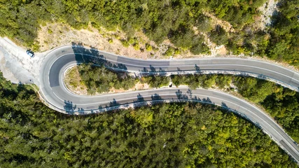 Fototapeten Aerial view of the movement of vehicles on a serpentine mountain road. Croatia © Oleksii Nykonchuk