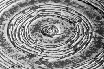 Part of old ceramic plate close-up in black and white.