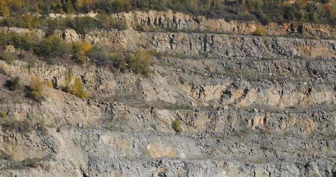 Crushed stone mining in an open quarry. Gravel crushed stone. A crushed stone quarry on a summer day. A stone quarry. View from above.