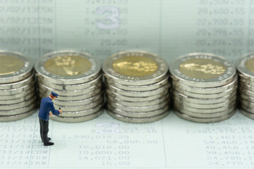 Money laundering concept. Miniature  people, officer investigating coins stacks and customer...