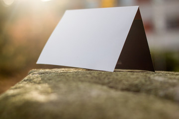 white card on a stone slab