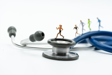 Miniature people running stethoscope. Health care and medical.