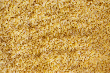 Bulgur wheat yellow background and texture pattern