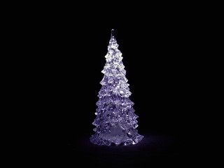 Christmas tree glowing in the black background