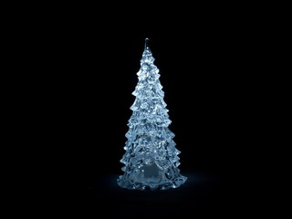 Christmas tree glowing in the black background